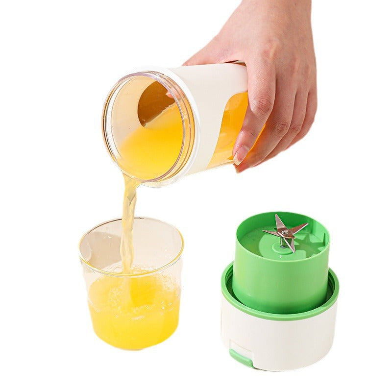 Portable Vinzona electric juicer for citrus fruits, showing compact design and recharging USB port for fresh orange juice.