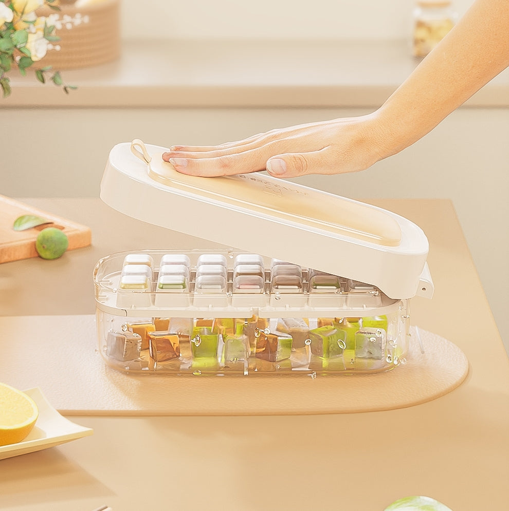 VinZona large food-grade ice cube tray with grid for reusable ice making, shown filled with water in a freezer.